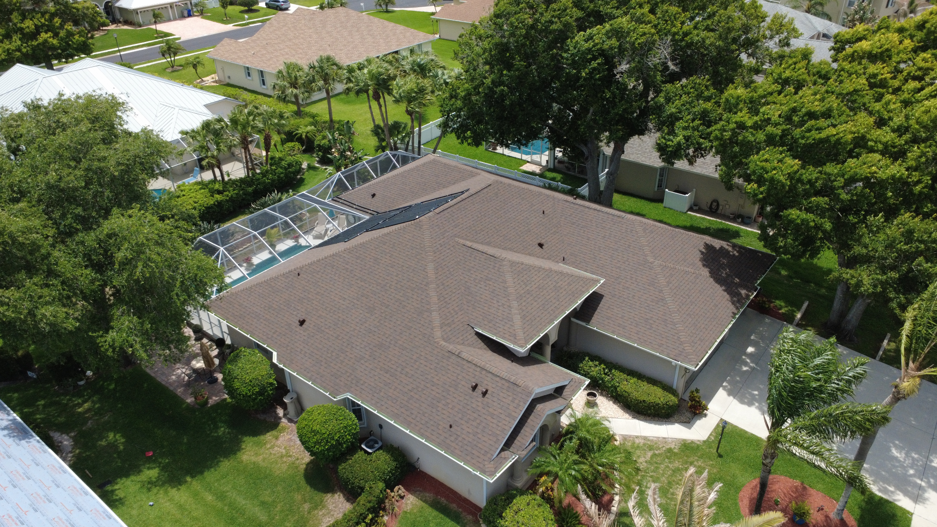 Aerial view of a completed asphalt shingle roof replacement in Brevard County, Florida