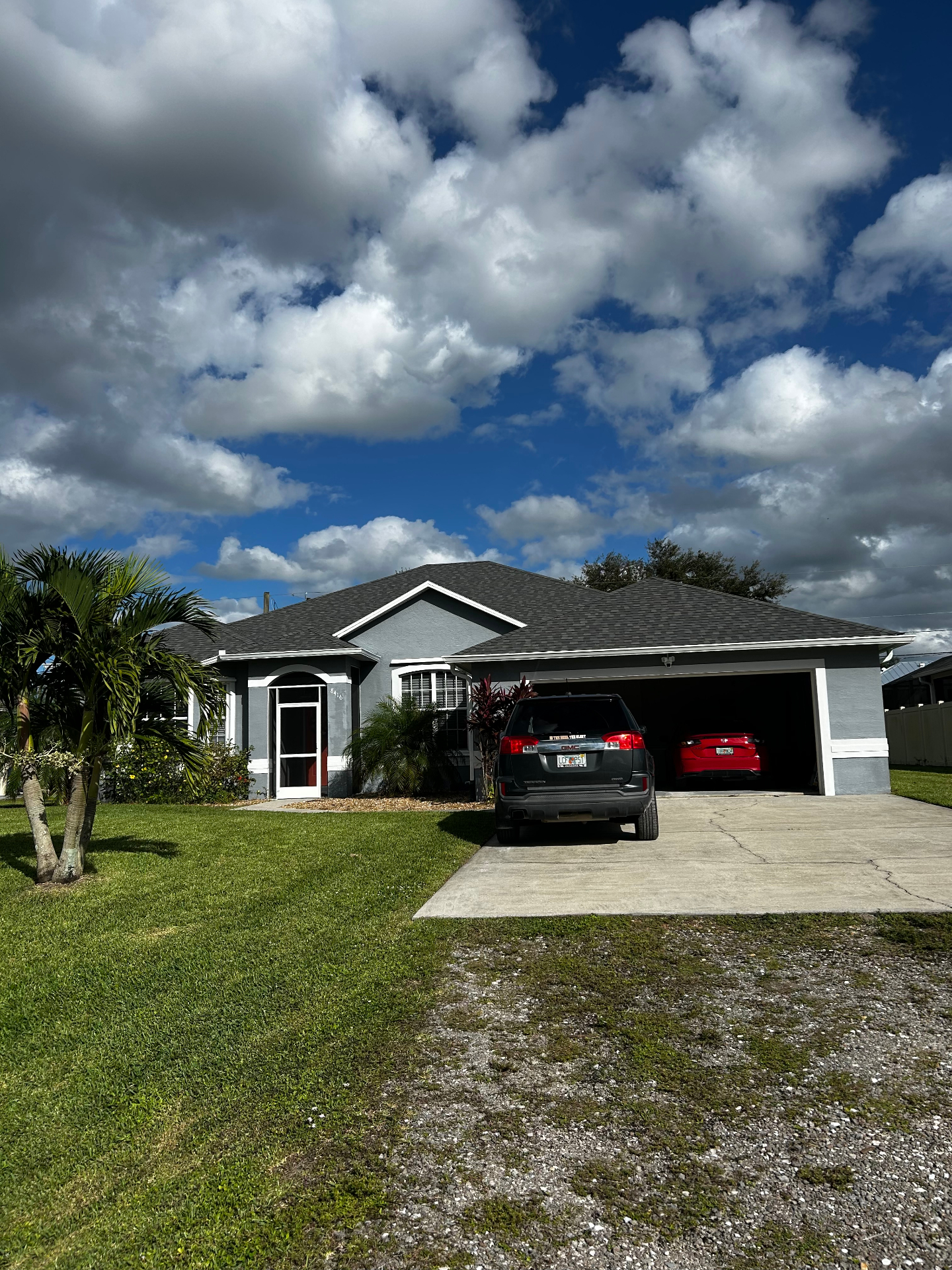 Completed gray architectural shingle roof on a Florida home with two-car garage